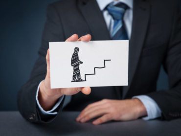Personal development (personal growth), success, progress, potential and career concepts. Male coach (human resources officer, supervisor) with card and drawn stairs to help employee with his career growth.